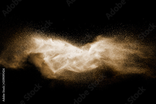 Brown particles splattered on black background.