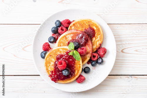 pancake with fresh raspberries and blueberries photo