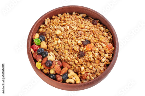 Bowl of homemade granola with fruit pieces isolated on white