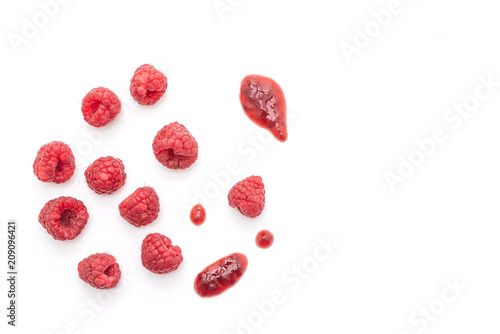 fresh raspberries  with raspberry jam or sauce on white background