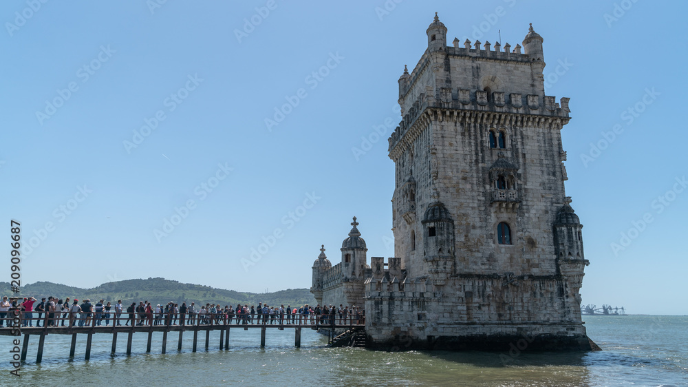 Tourists in queue to visit the Belem tower at the bank of Tejo River in Lisbon, Portugal