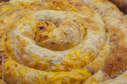 Closeup of Traditional meal from Bulgaria - Tikvenik. Made of handmade pastry leaves stuffed with pumpkin, walnuts, sugar and cinnamon photo