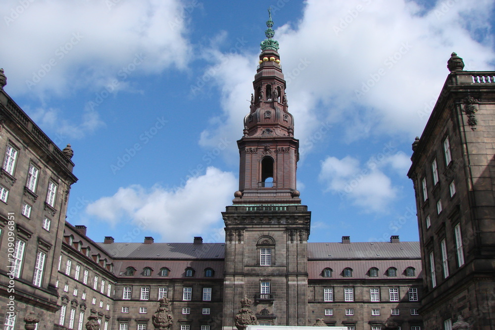A panorama of parks and ancient castles in historic areas of Copenhagen against the background of the blue sky.