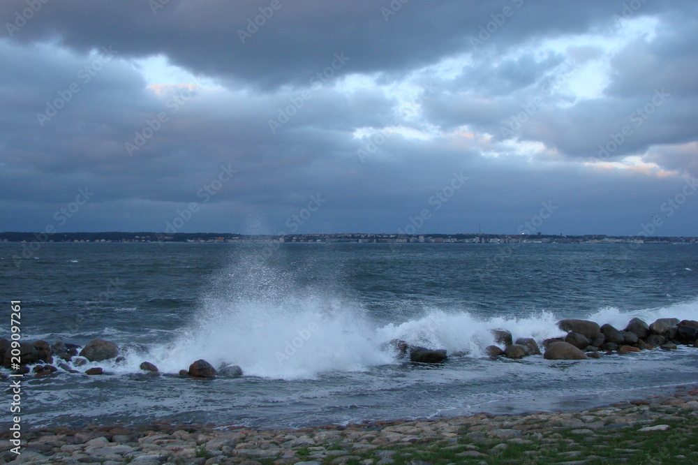 Fototapeta premium Panorama of the troubled North Sea near the coast of Denmark against the background of rainy clouds.