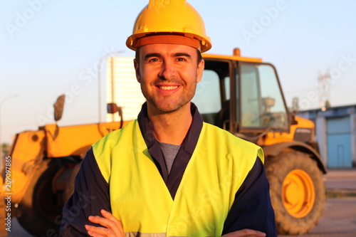 Joyful handsome labourer at work