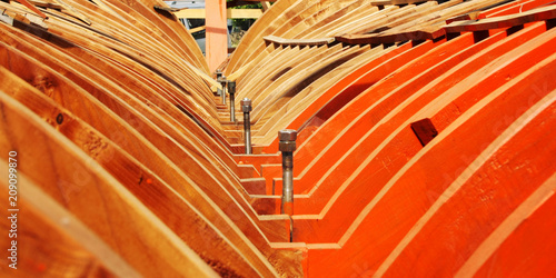 Building a boat. Under construction. Toned photo. The wooden keel beams. Orange wood. Colorful image. Traditional methods. Turkey.
