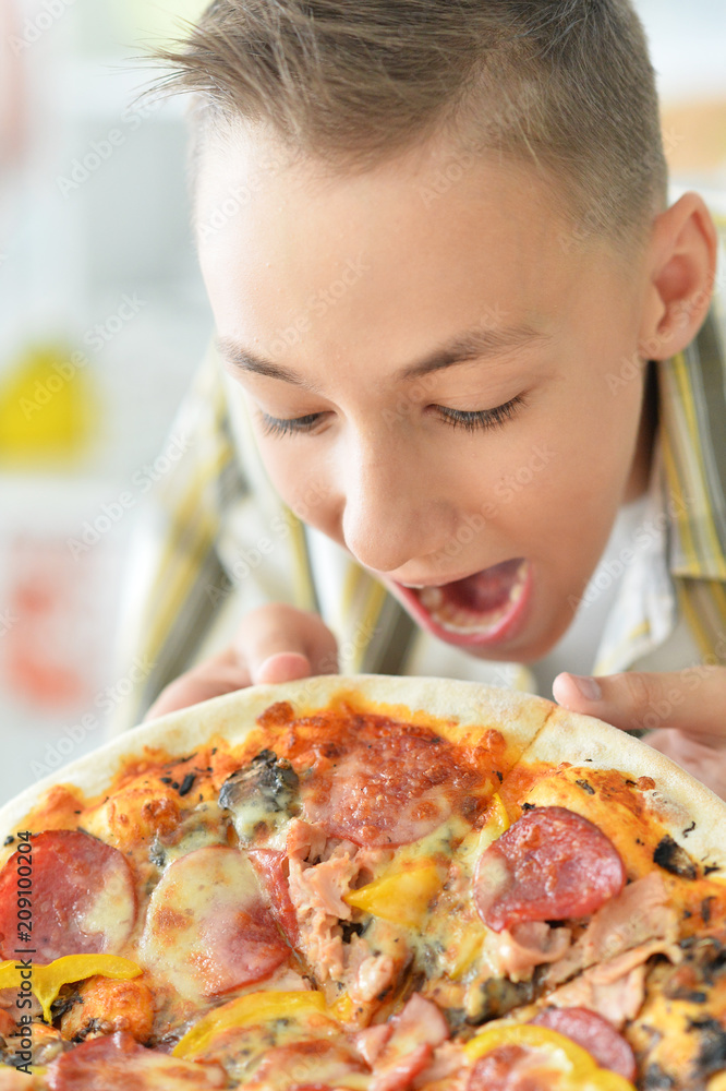 Young boy with pizza