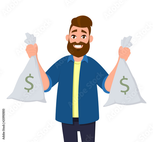 Smiling businessman with cash bags in each hands.