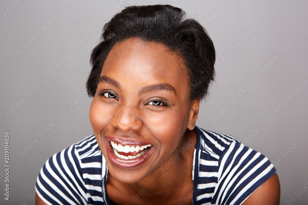 Close up happy woman in striped shirt laughing Close up happy woman in striped shirt laughing