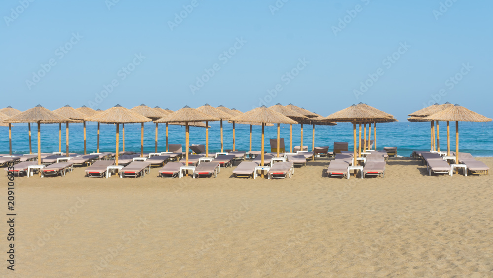 straw parasols on the beach of Falassarna, Crete