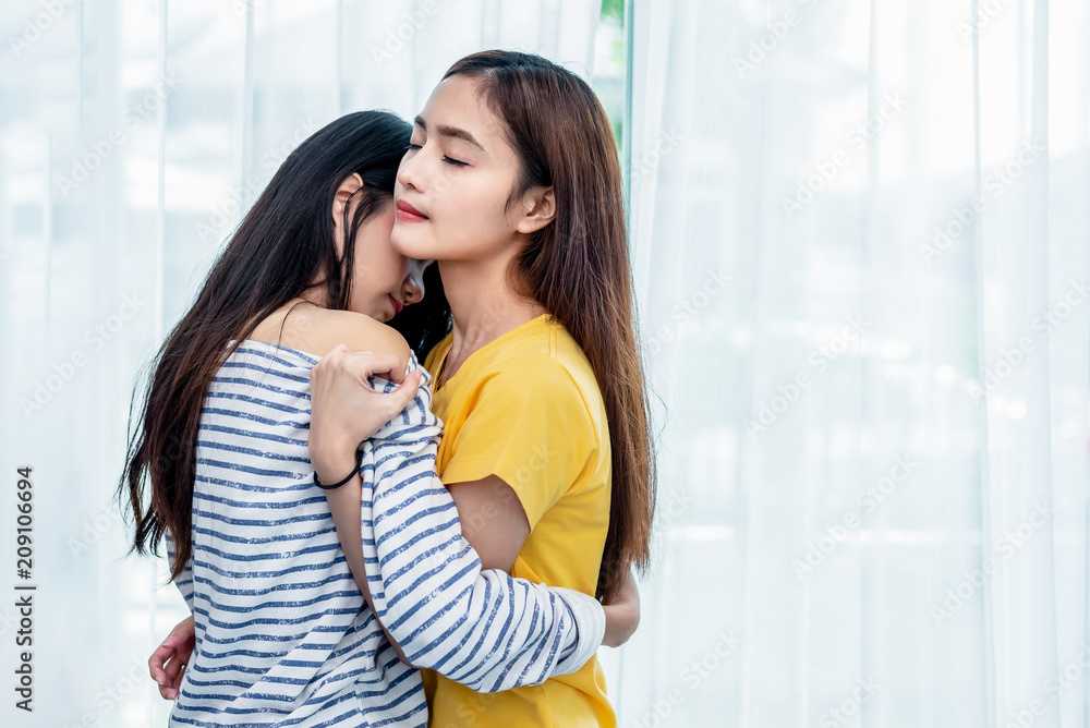 Two Asian Lesbian women looking together in bedroom. Couple people and Beauty concept. Happy lifestyles and home sweet home theme. Embracing of homosexual. Love scene making of female Two Asian Lesbian women looking together in bedroom. Couple people and Beauty concept. Happy lifestyles and home sweet home theme. Embracing of homosexual. Love scene making of female