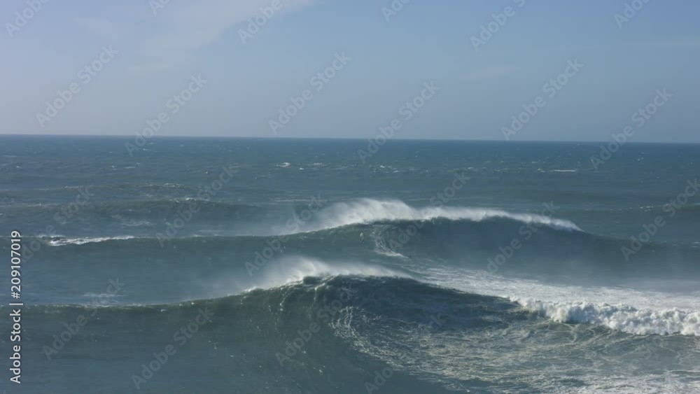 Kitesurfer surfing a big wave in Praia do Norte, Nazaré Kitesurfer surfing a big wave in Praia do Norte, Nazaré