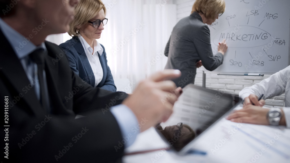 Female marketer adding one more branch to marketing presentation, strategy Female marketer adding one more branch to marketing presentation, strategy