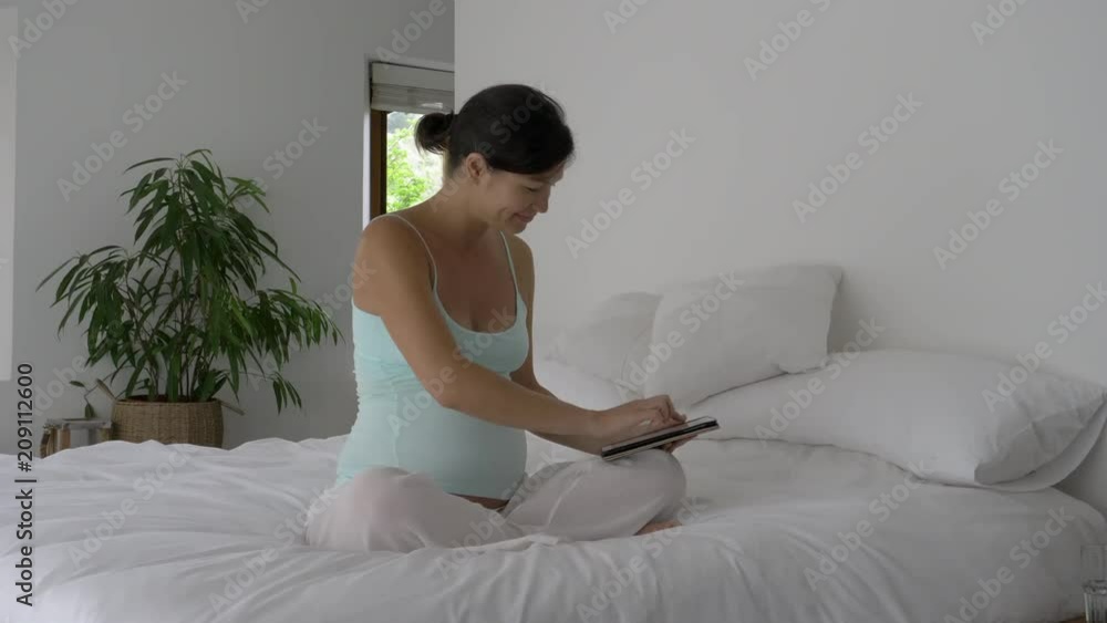 Pregnant Asian-american woman resting during the daytime Pregnant Asian-american woman resting during the daytime
