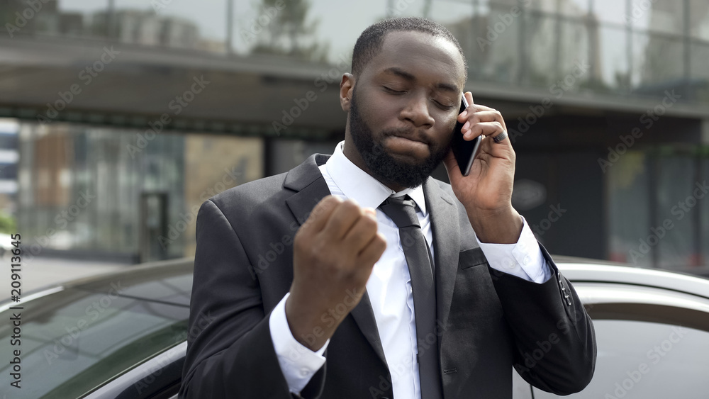 Businessman annoyed by unpleasant phone conversation, problems in business Businessman annoyed by unpleasant phone conversation, problems in business