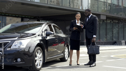 Wallpaper Mural Scrupulous secretary clarifying contract details with boss near parked car Torontodigital.ca