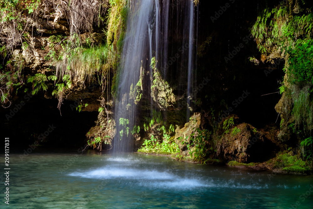 Waterfall and a beautiful lagoon lake for relaxing in the summer forest. Waterfall and a beautiful lagoon lake for relaxing in the summer forest.