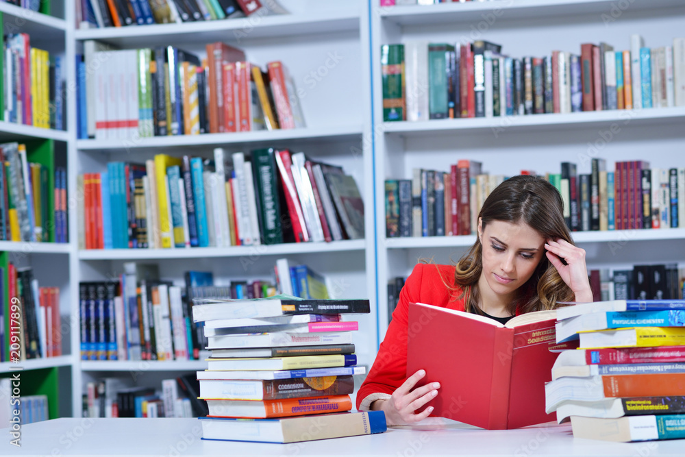 Beautiful female student in a university library Beautiful female student in a university library