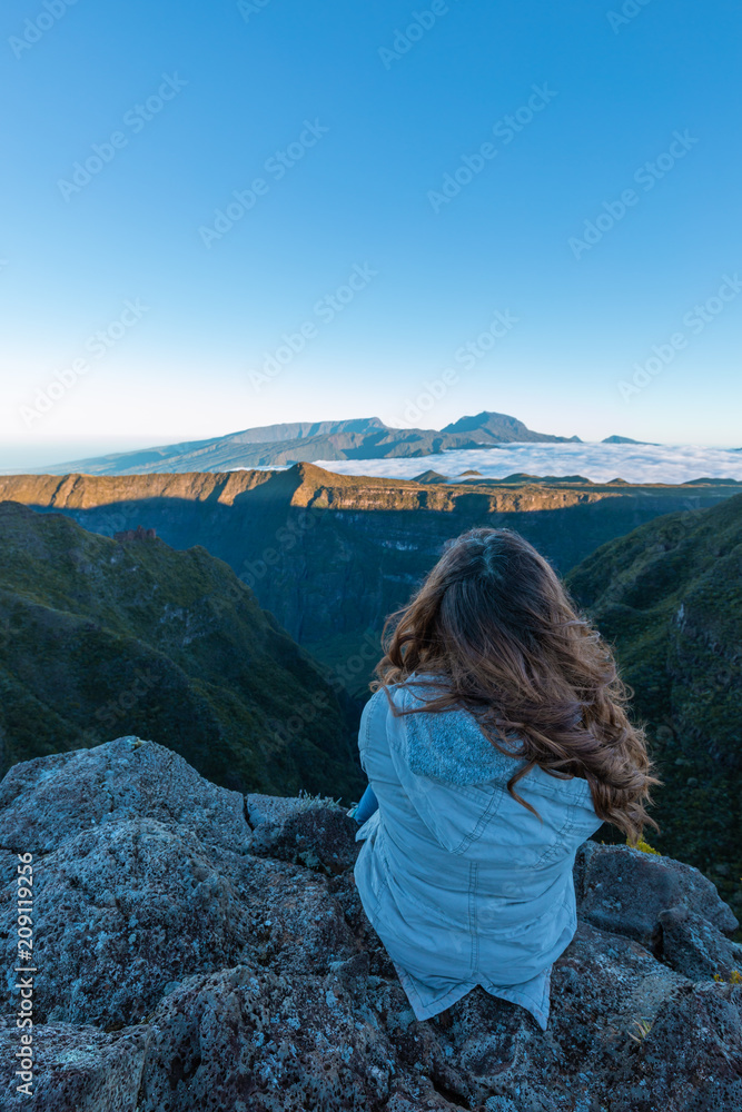 Girl watching the Piton des Neiges from the Riviere des Remparts in Reunion Island