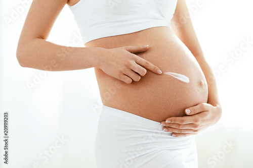 Pregnant Belly Skin Care. Belly With Cream On Skin