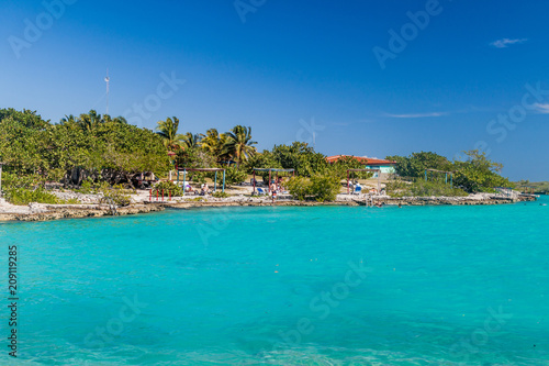 PLAYA GIRON, CUBA - FEB 15, 2016: Tourists enjoy the seaside resort Caleta Buena at Bay of Pigs near Playa Giron village, Cuba.