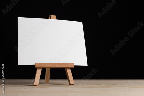 A small easel, a layout, a blank, white on a black background. © Plutmaverick