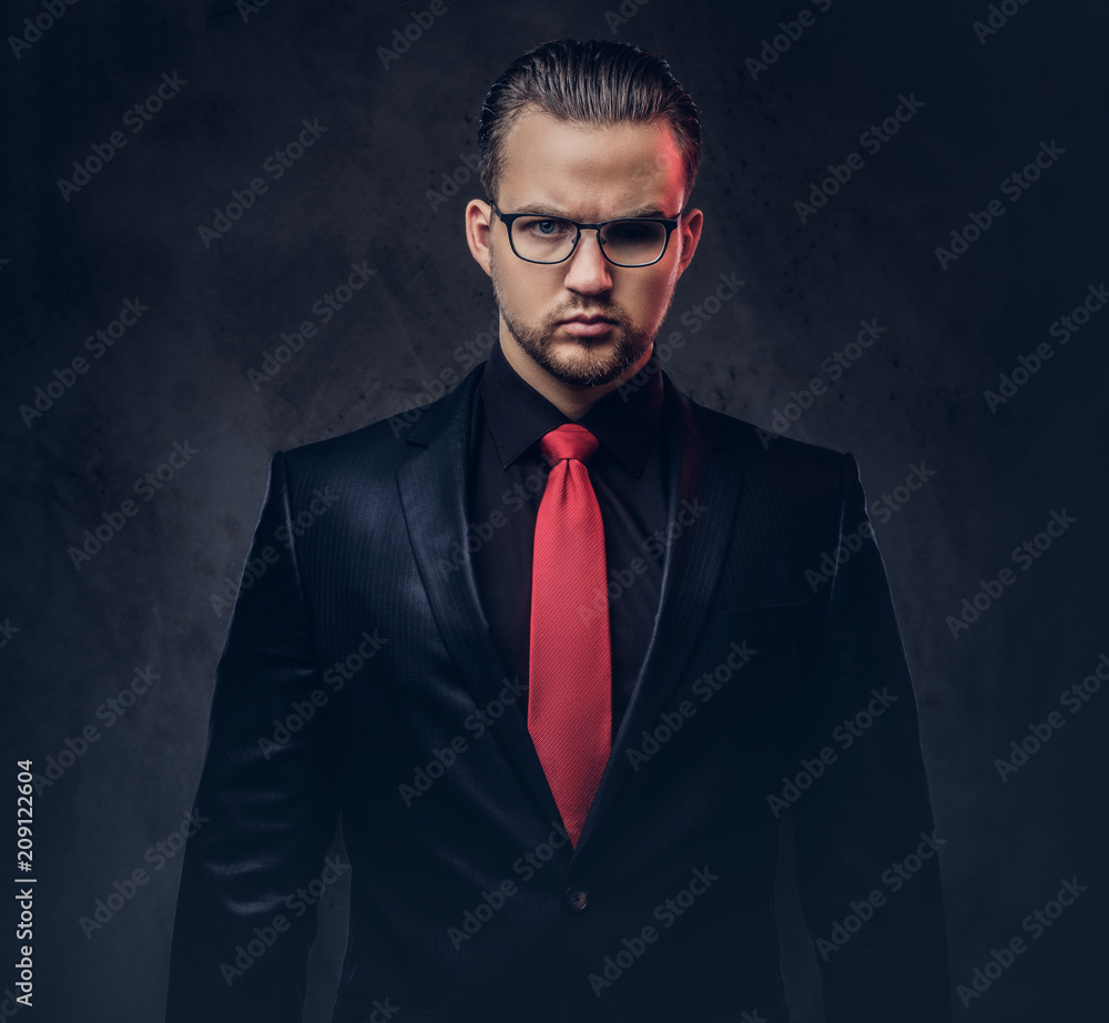 Portrait of a stylish male in a black and red tie. on a dark background. Stock Photo | Adobe Stock