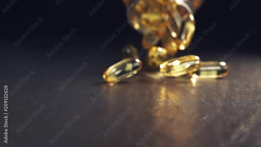 glass full of capsules poured out. Close up and slow motion. glass full of capsules poured out. Close up and slow motion.