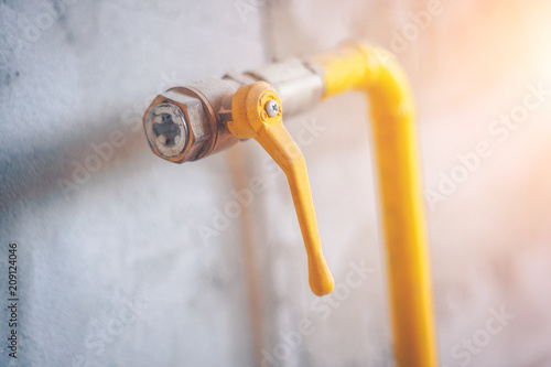 Close up of a yellow gas pipe in the house