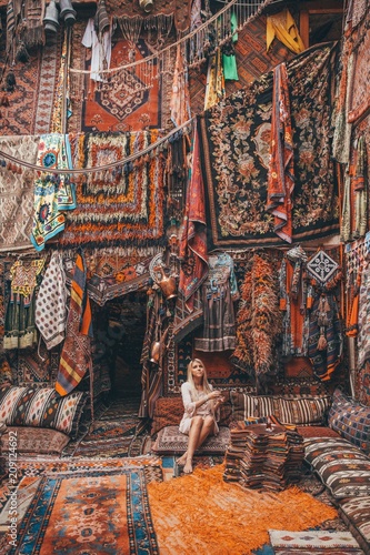 Woman drinking a tea in a carpet store in Cappadocia