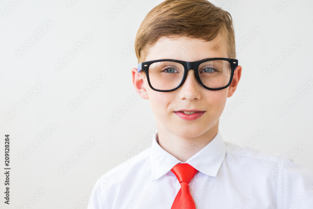 Portrait of young businessman of boy in a shirt and spectacled. Successful teenager on a white background