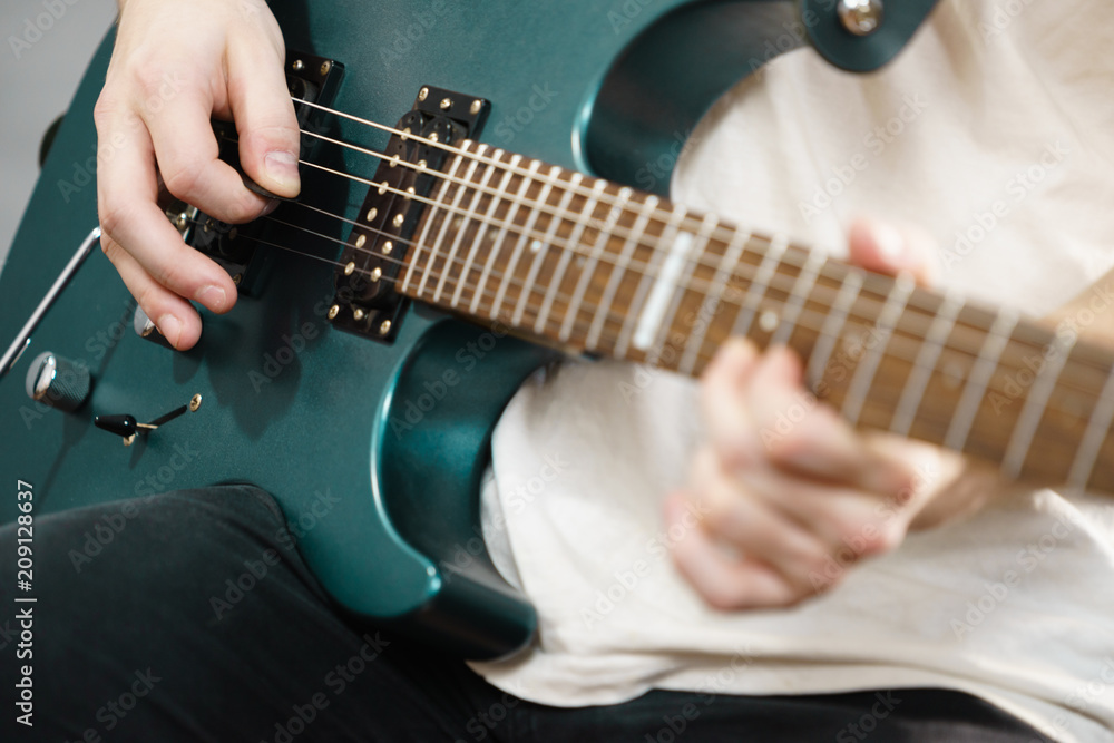 Fototapeta premium Close up of man playing on electric guitar