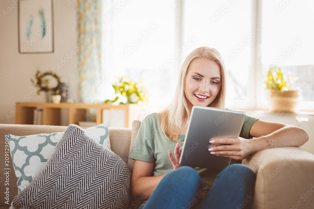 Beautiful young woman using digital tablet at home Beautiful young woman using digital tablet at home