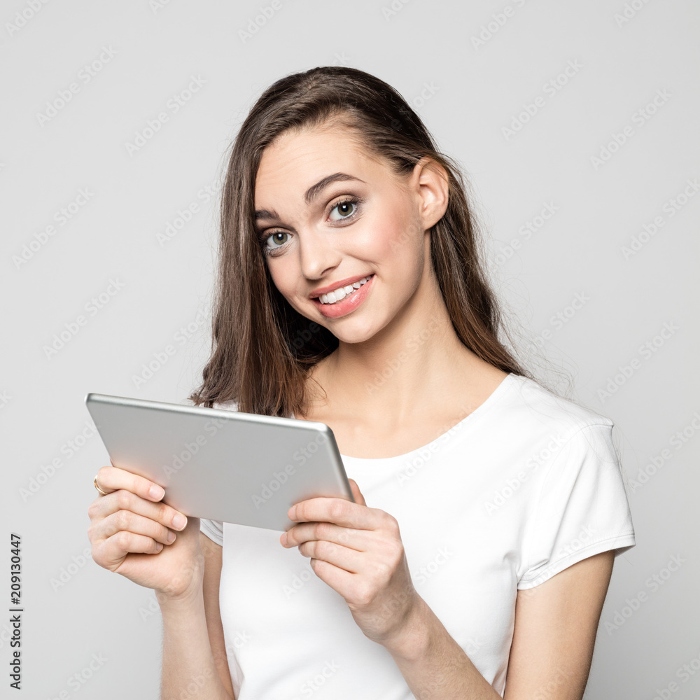 Portrait of cheerful young woman holding digital tablet Portrait of cheerful young woman holding digital tablet