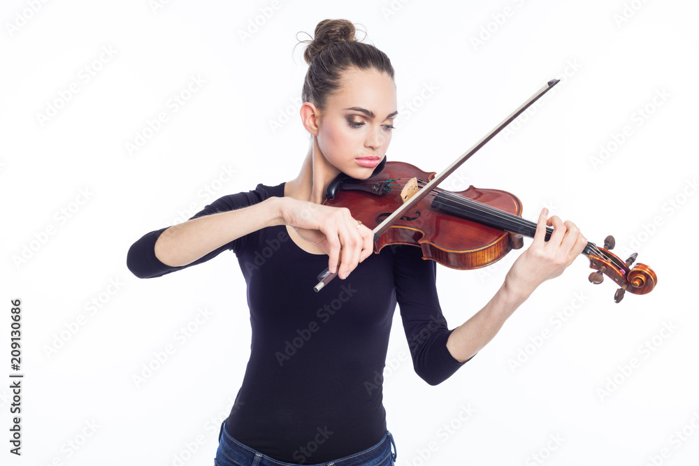 Beautiful young woman playing violin, studio shot Beautiful young woman playing violin, studio shot