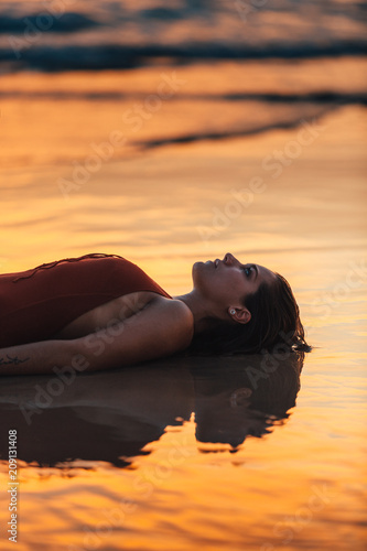 Cute young woman lying in the seshore photo