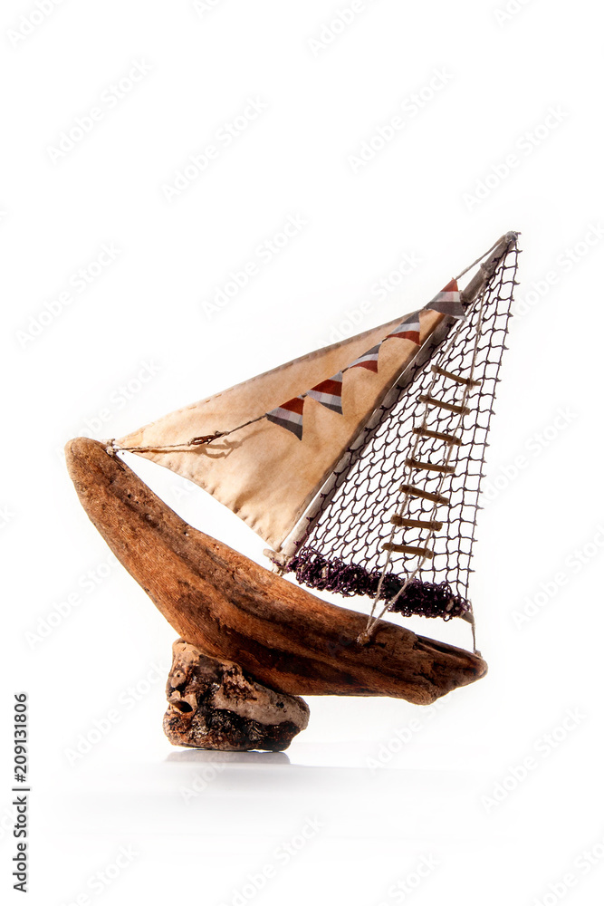Obraz premium Sailboat or fishing boat made of wood as nautical decoration on white background