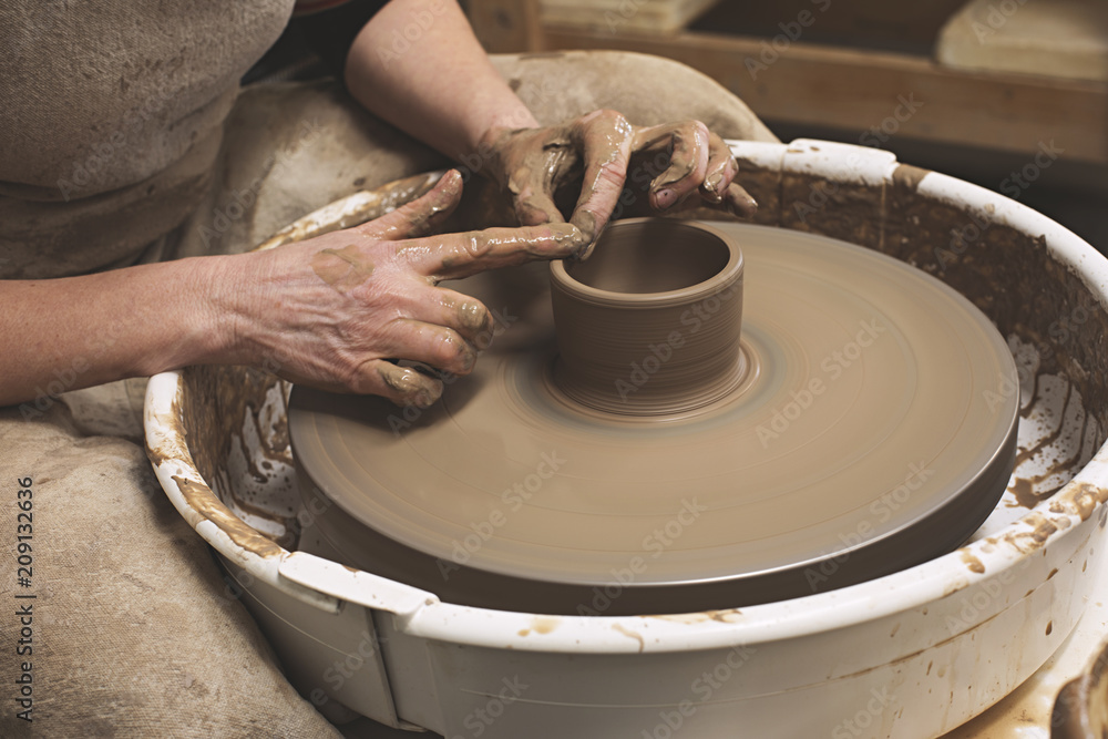 A ceramic Artist works in her potter studio A ceramic Artist works in her potter studio