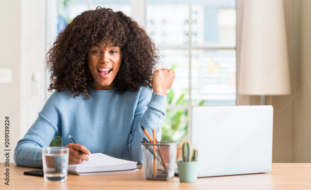 African american woman studying at home using a computer laptop ...
