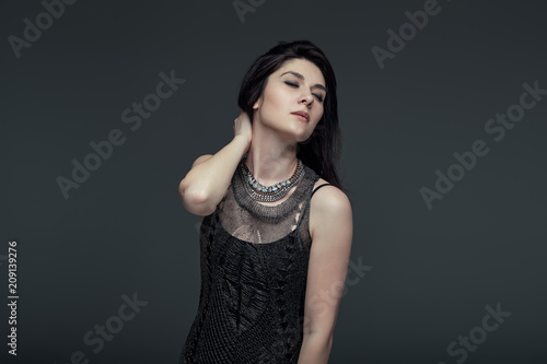 Portrait brunette attractive woman, accent on arms and face expr