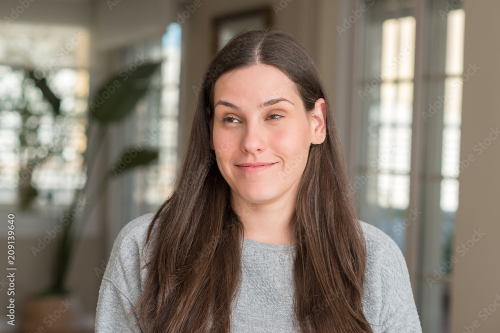Young beautiful woman at home smiling looking side and staring away thinking. Young beautiful woman at home smiling looking side and staring away thinking.