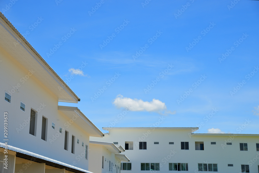 Townhouse  with blue sky and fluffy clouds background.