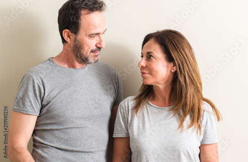 Middle age couple, woman and man with a confident expression on smart face thinking serious