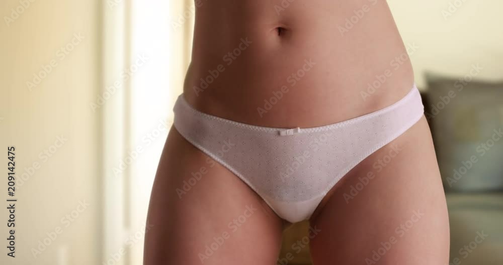 Close up of slender young woman wearing white panties standing in bedroom, Healthy fit woman in white underwear in private living space, 4k Stock ビデオ | Adobe Stock 