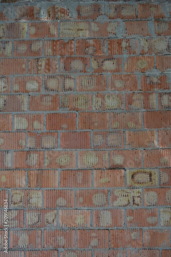Red clay bricks with cement and brickwork of red, orange, yellow with gray and relief stripes