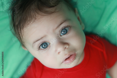 Beautiful baby with big blue eyes photo