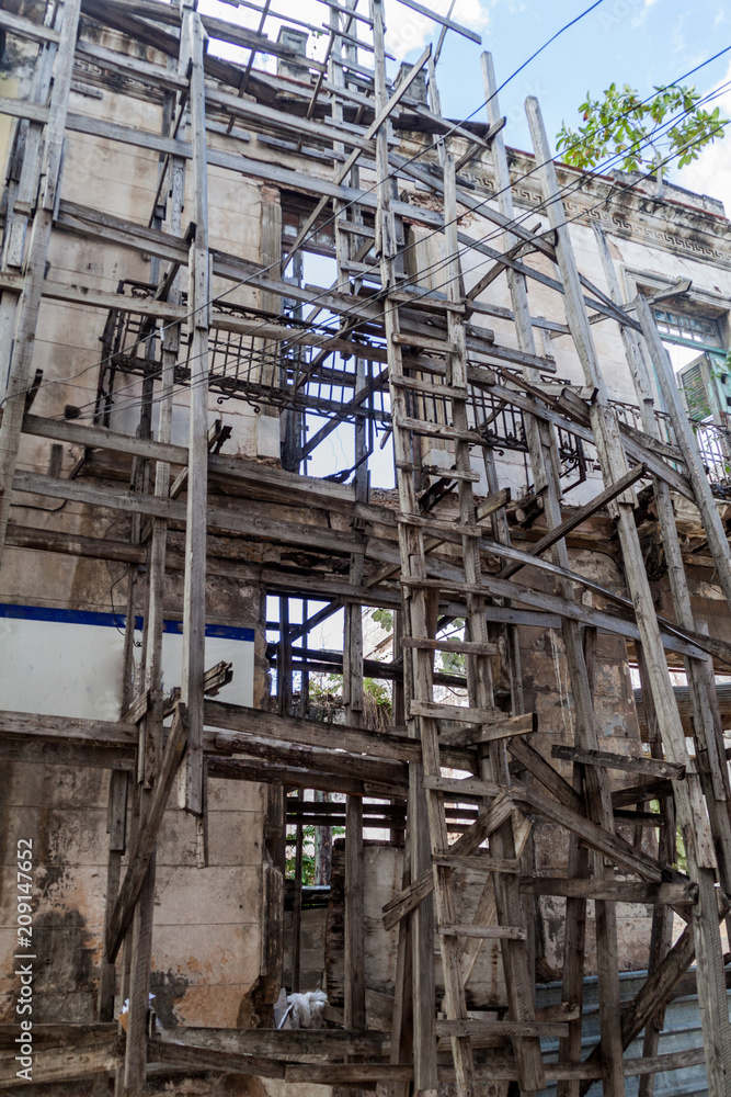Wooden scaffolding holding a dilapidated building in Havana, Cuba.