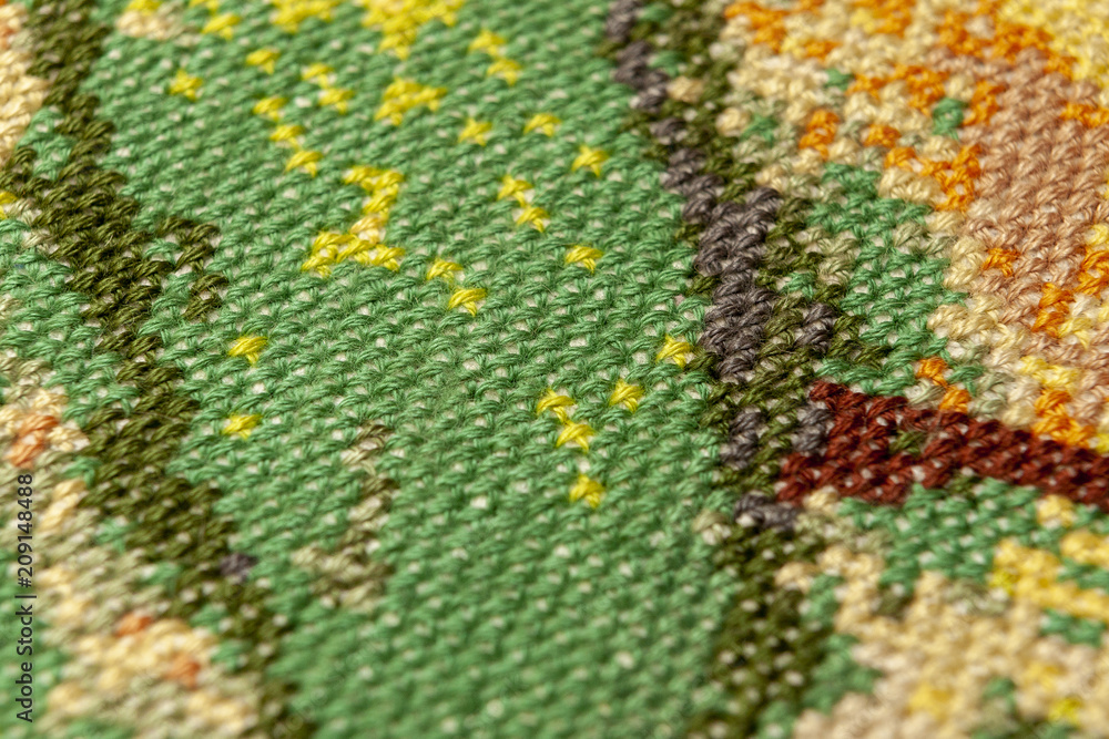 Cross-stitch. Macro photography of embroidery sites. Shooting with a small bluff of sharpness