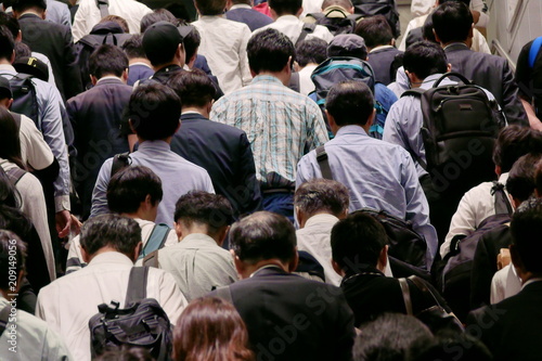 many people walking up stairs to work in the early morning