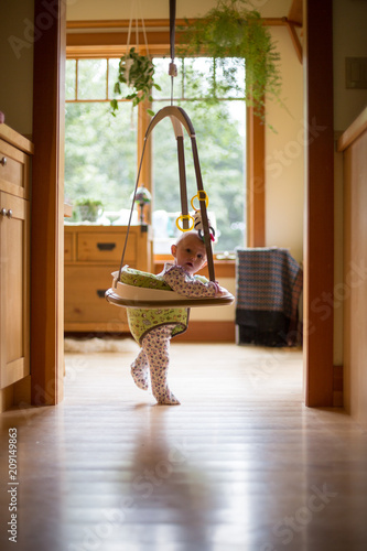 A baby plays in her jumper photo